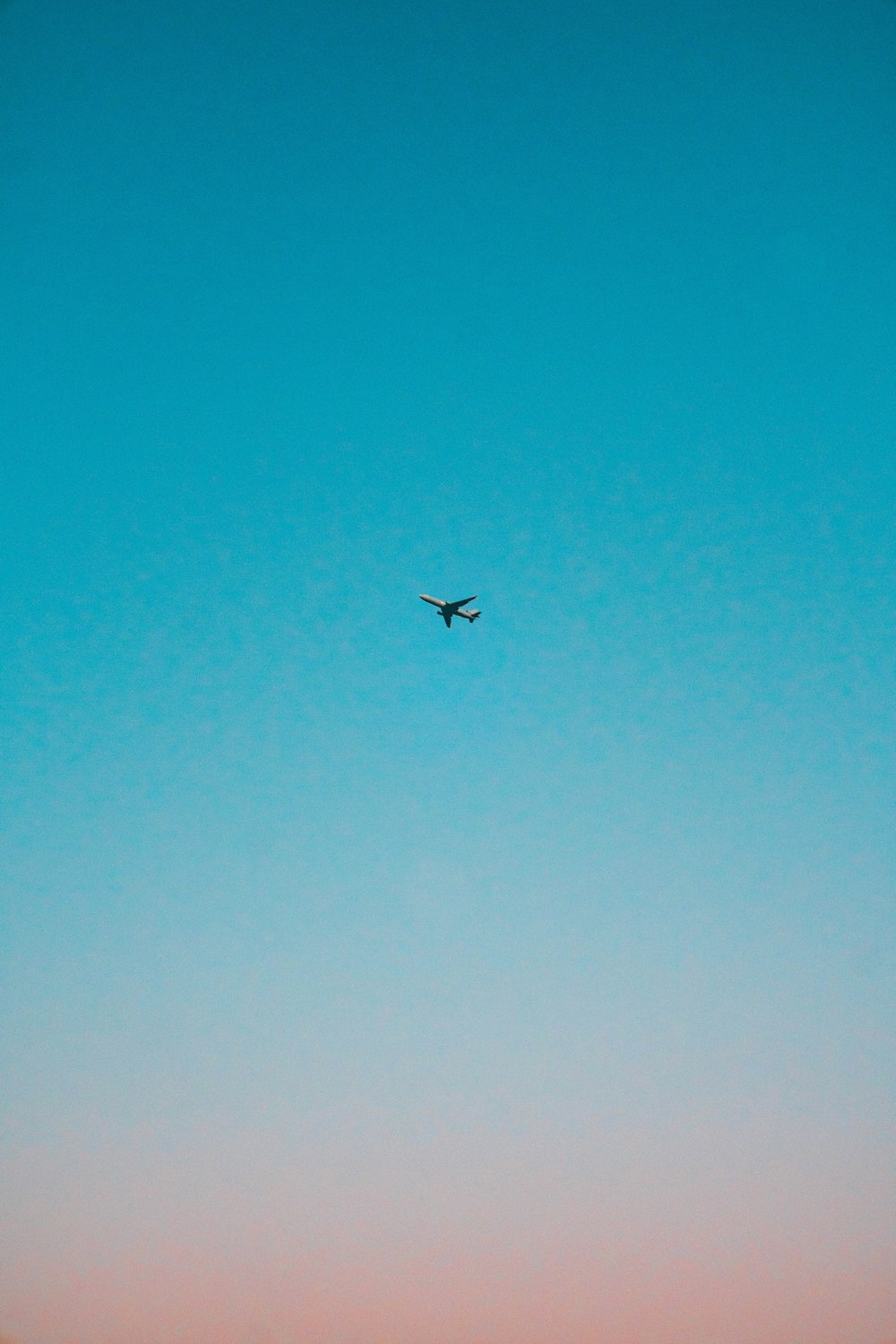 flying airplane under blue sky
