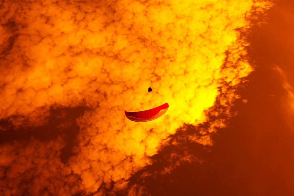 a kite flying through a cloudy sky on a sunny day