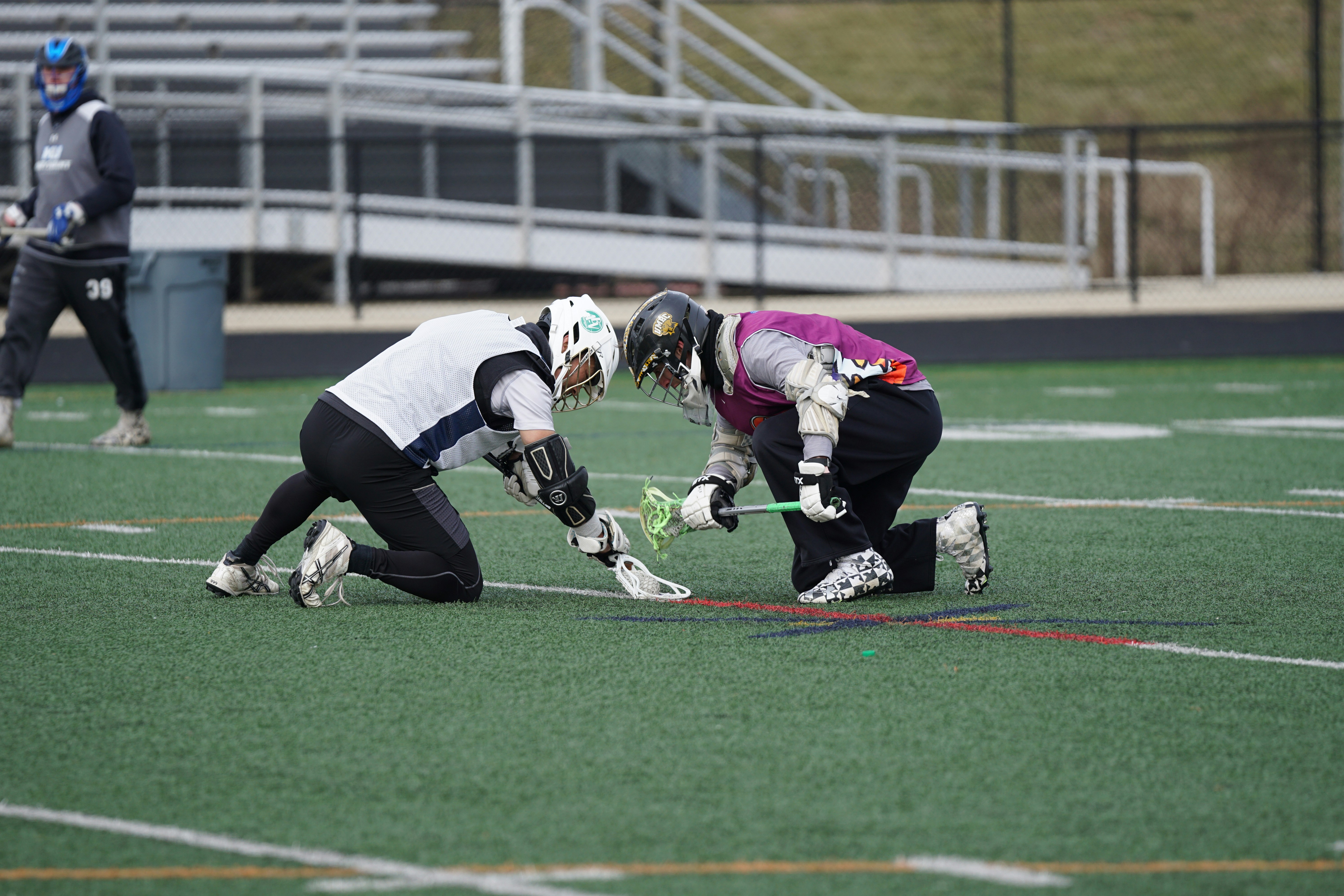 two men playing lacrosse sports