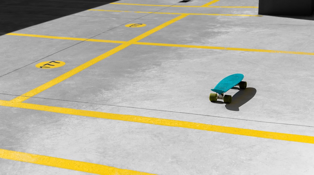 green longboard on gray concrete road