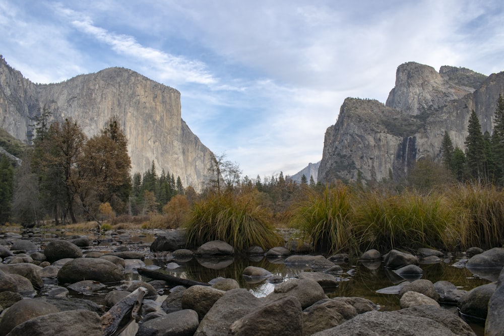 gray rocks beside body of water with view of mountains