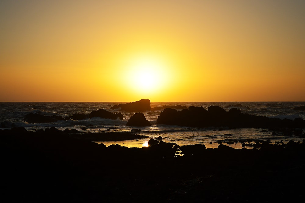 seashore with rocks with sunset view