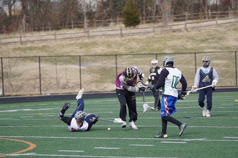 lacrosse players on field at daytime