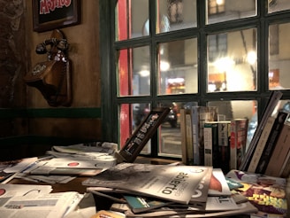 Cozy desk with museum brochures and a vintage telephone inviting visitors to connect.
