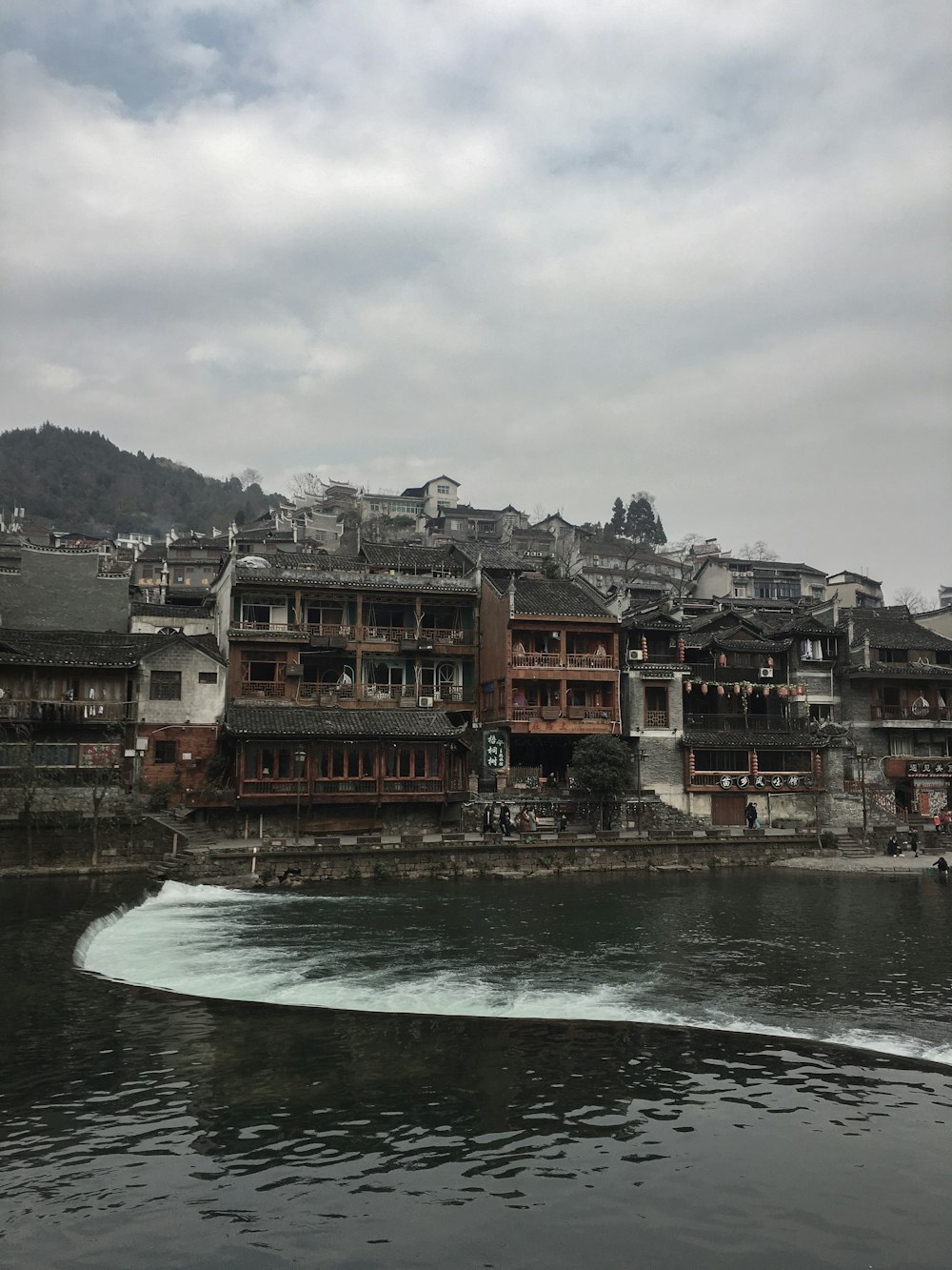 brown concrete buildings beside beach