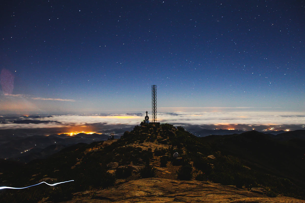 A communications tower on a hilltop at dusk