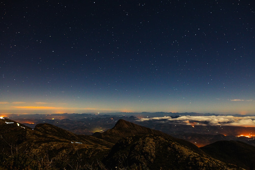 high-angle photography of brown mountains at night