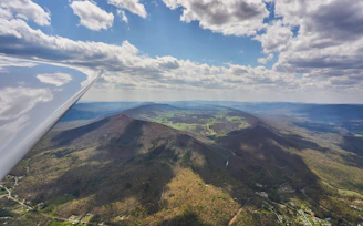 An aerial view from Aviara’s simulation showing a detailed landscape with mountains and rivers beneath the aircraft.