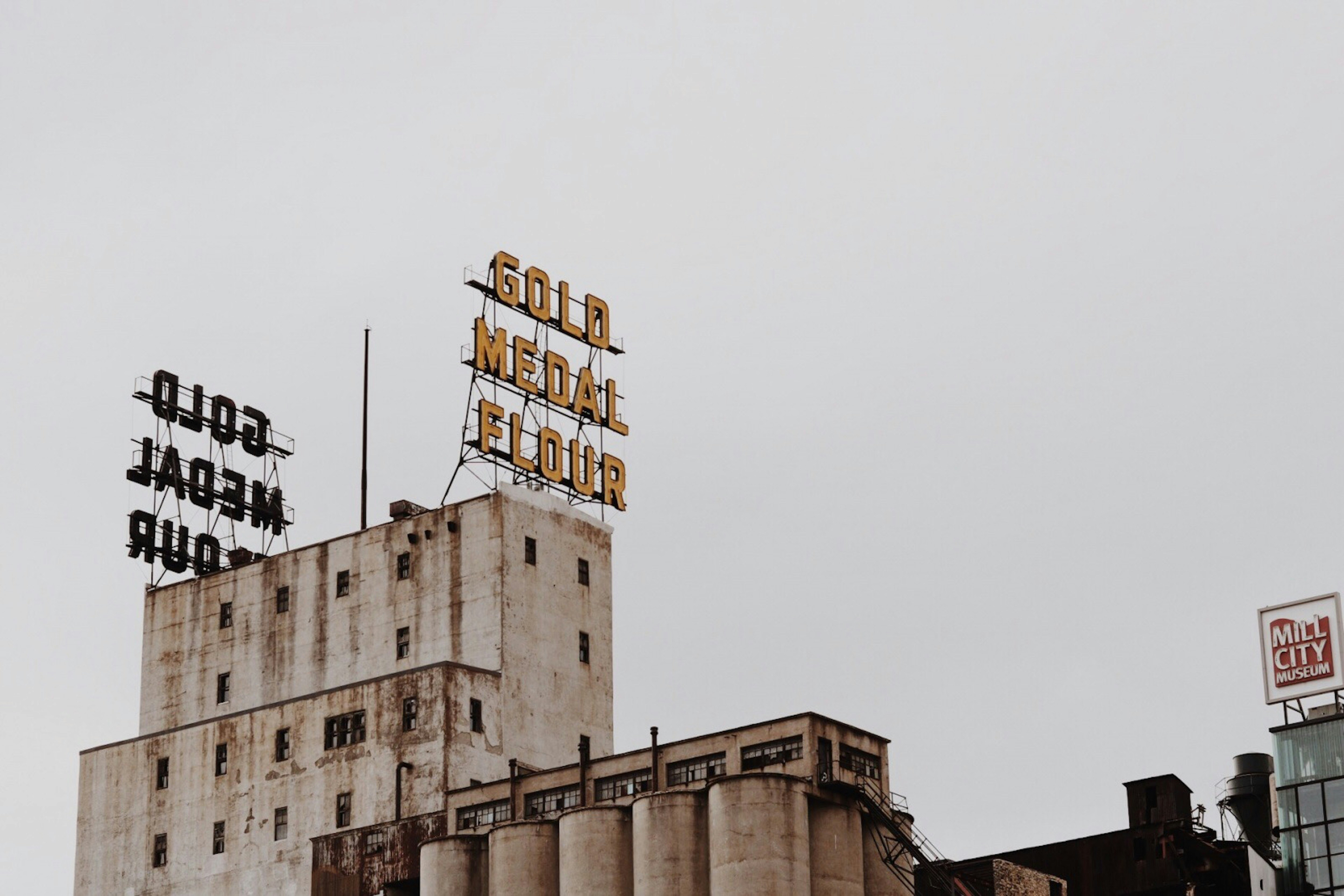 concrete building with lighted signage