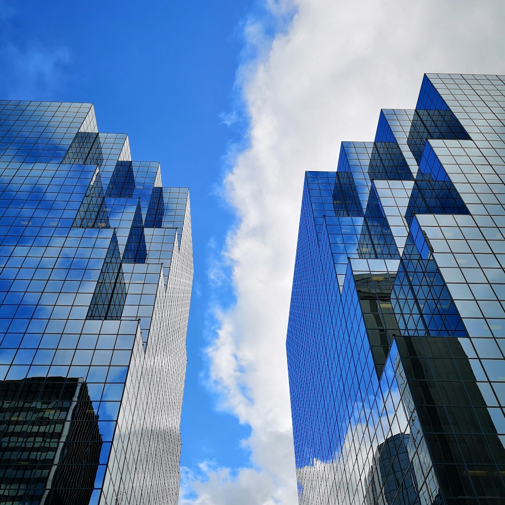 glass buildings under blue sky with clouds