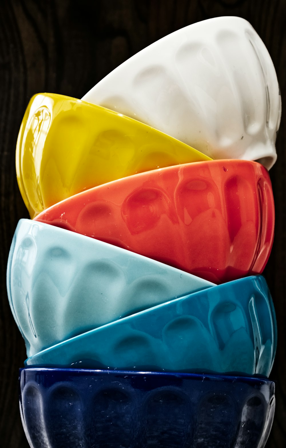 six assorted-colored bowls