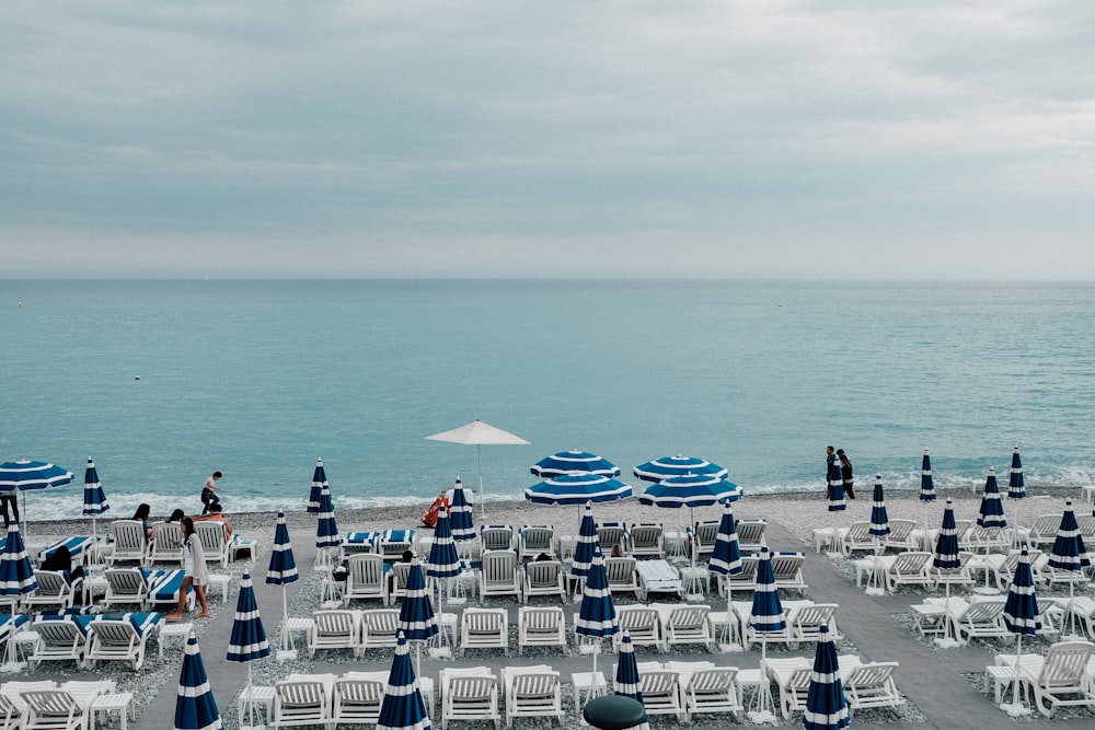 white lounger chair beside beach during daytime