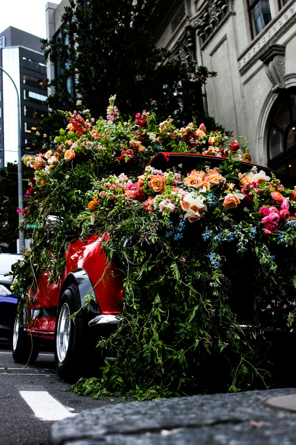 red vehicle covered with flowers