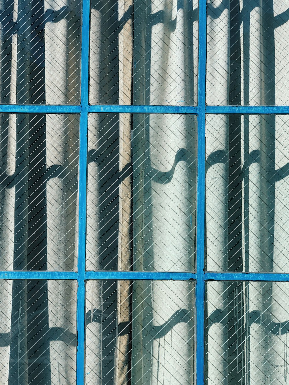 gray curtain and brown framed clear glass window during daytime