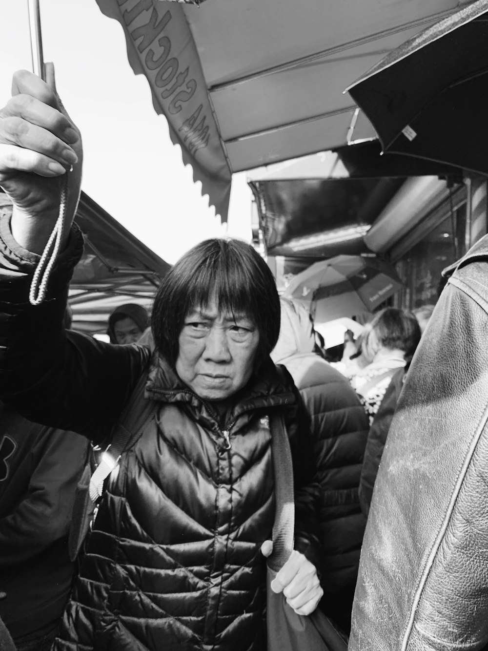 grayscale photography of a woman holding umbrella