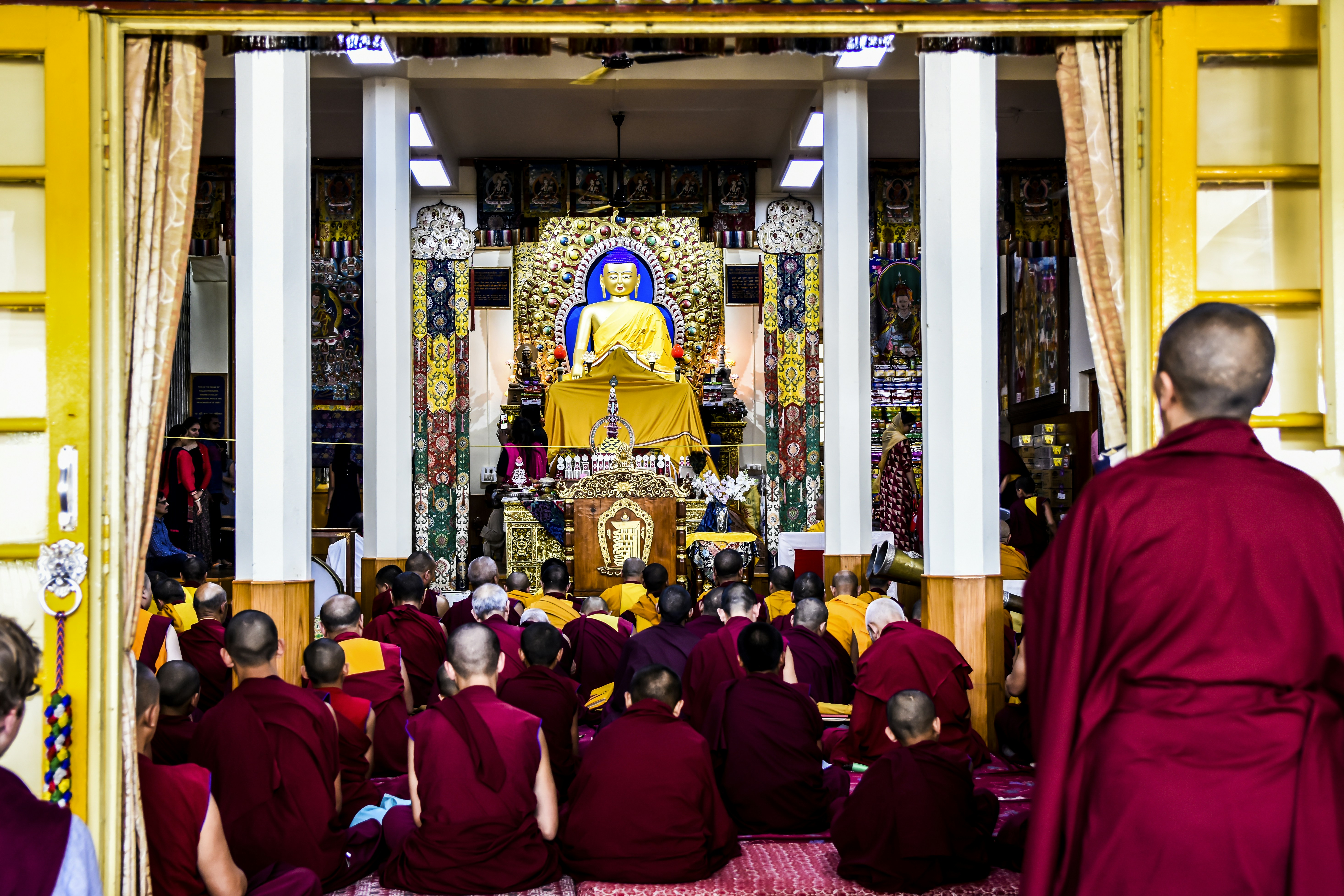 crowded people sitting in front of buddha