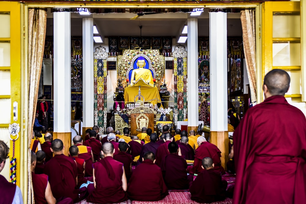 crowded people sitting in front of buddha