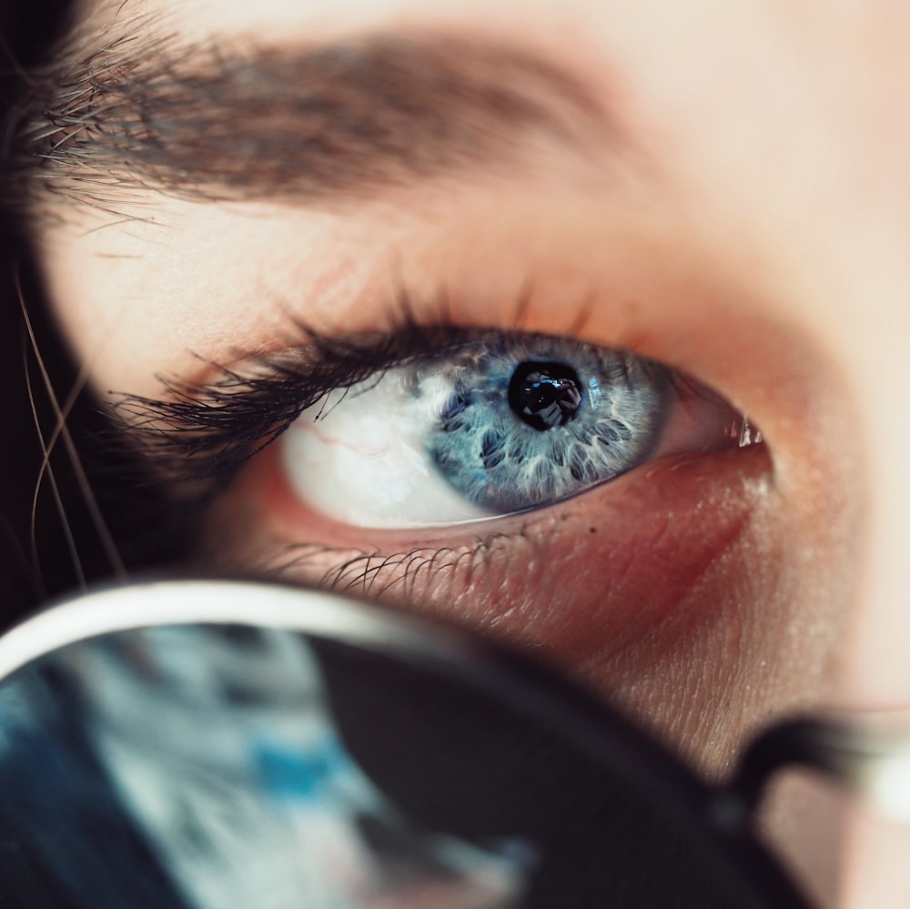 selective focus photo of person's eye iris and eye pupil