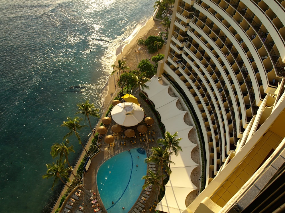 aerial photography of concrete building near swimming pool