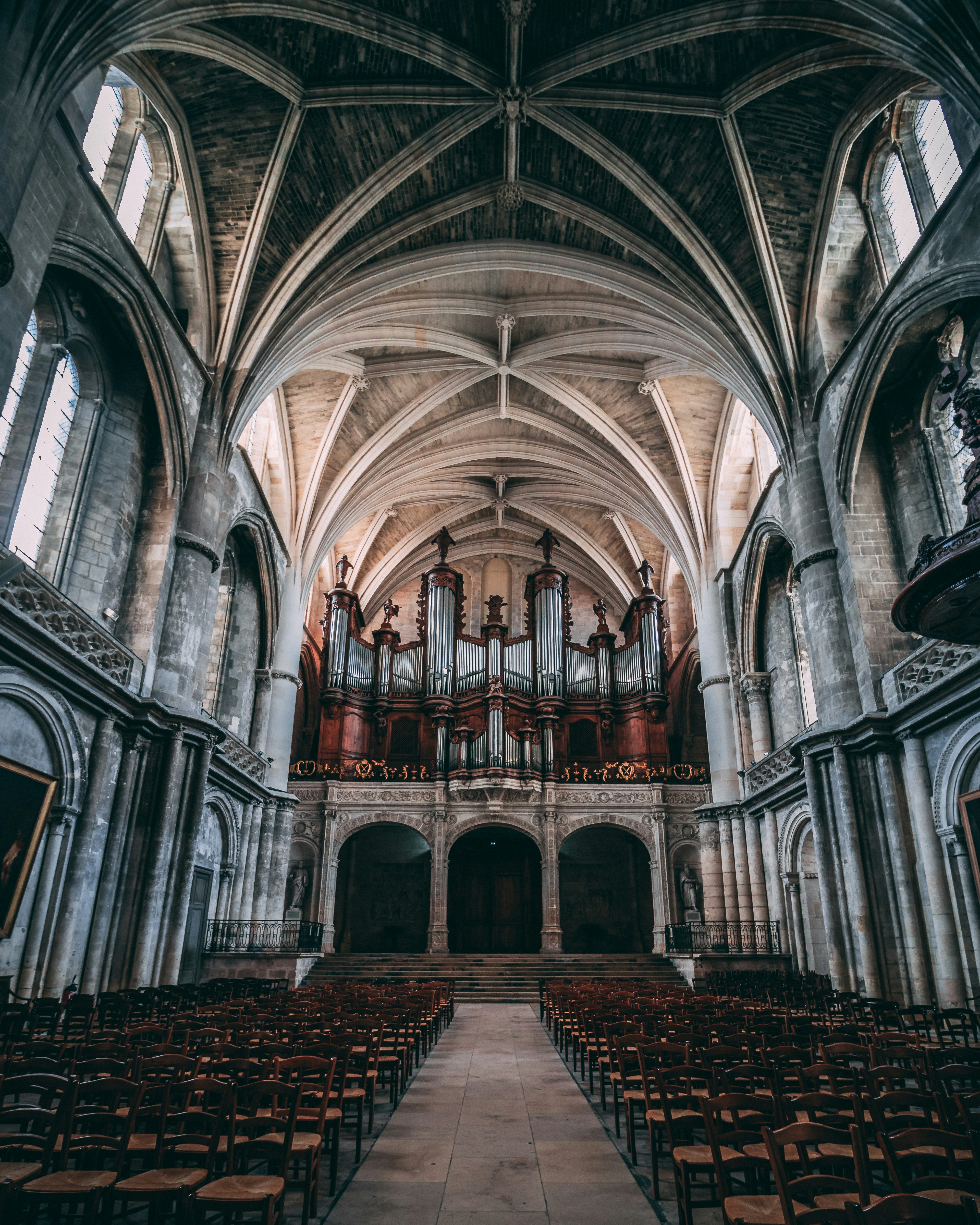 empty chairs inside concrete church during daytime
