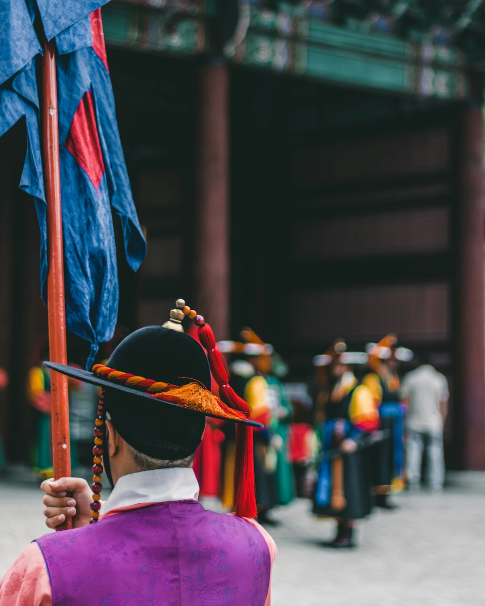 man holding blue flag