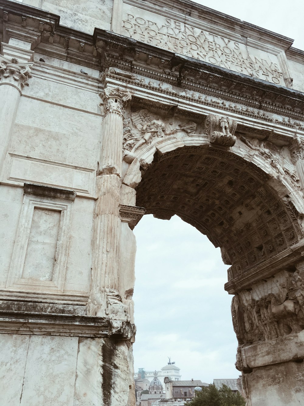 beige arch concrete gate during daytime