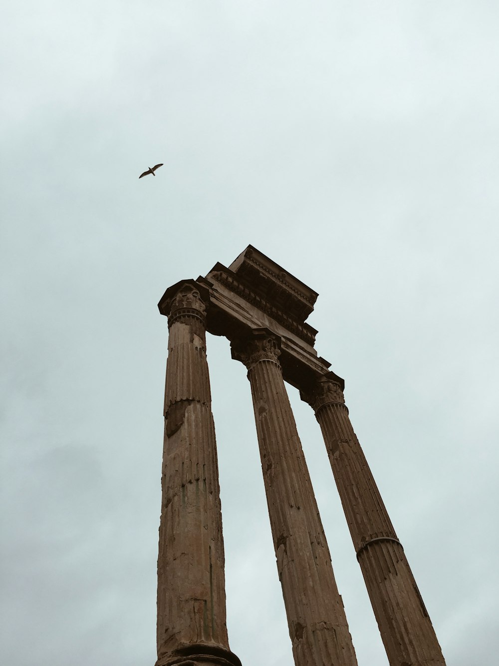 low-angle photography of gray concrete pillar during daytime