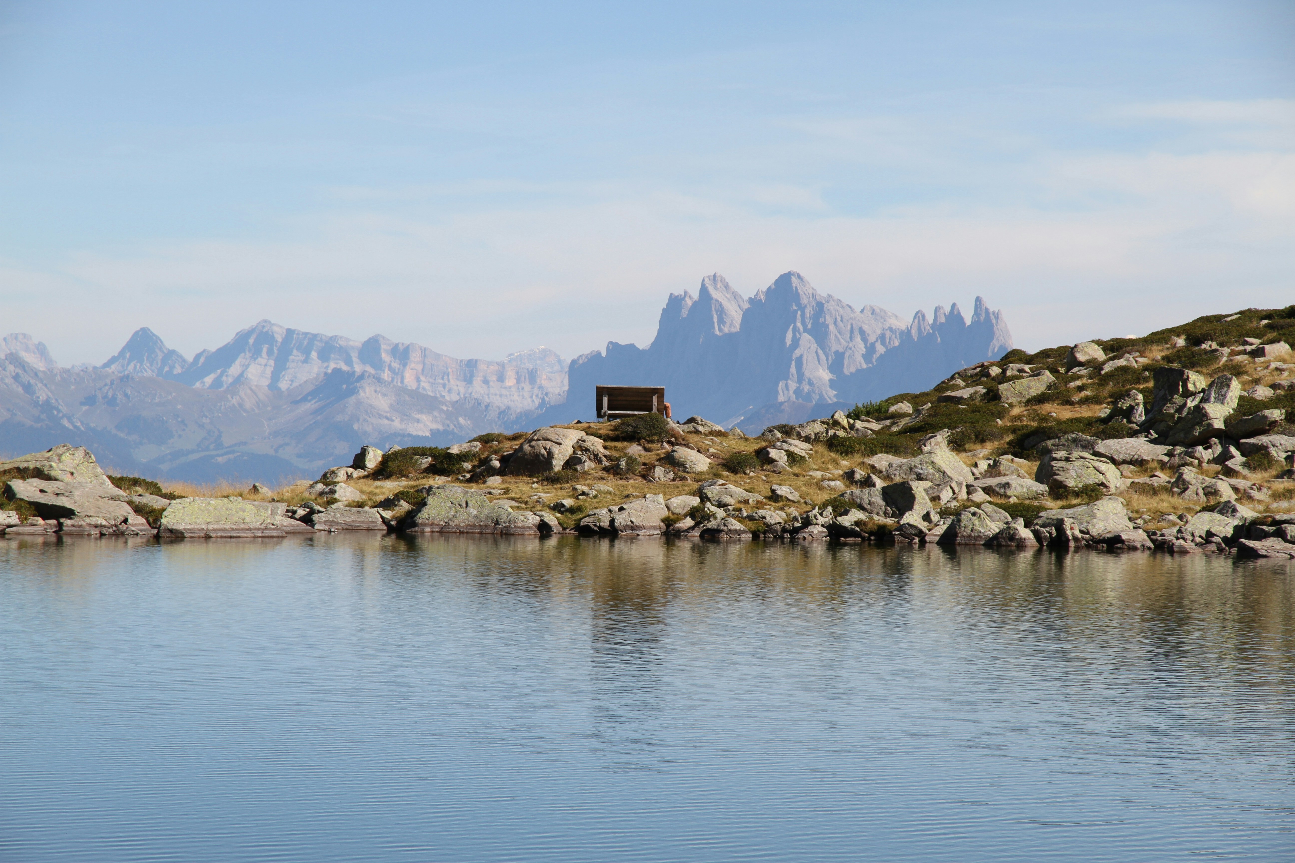 calm body of water near rocks during daytime