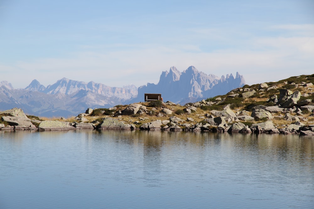 calm body of water near rocks during daytime