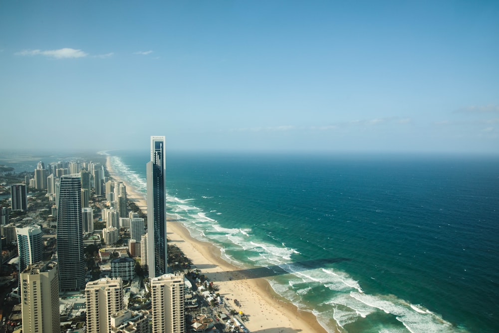 city buildings near sea under blue sky