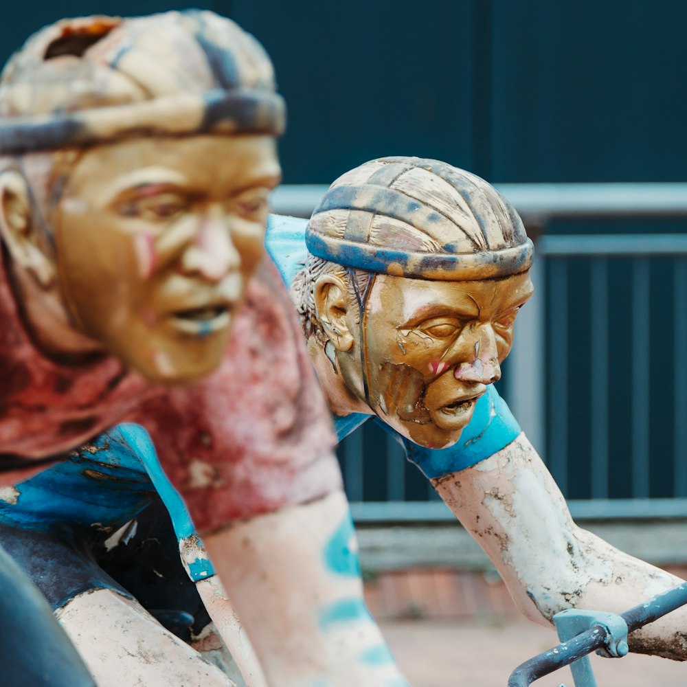 man riding bike statue