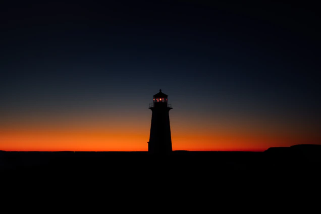Minimalist lighthouse silhouette glowing softly against a dark blue background.