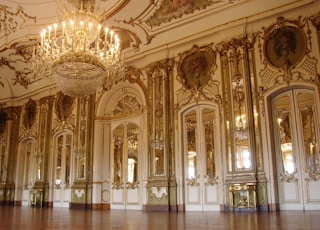 lighted chandelier inside white and brown building