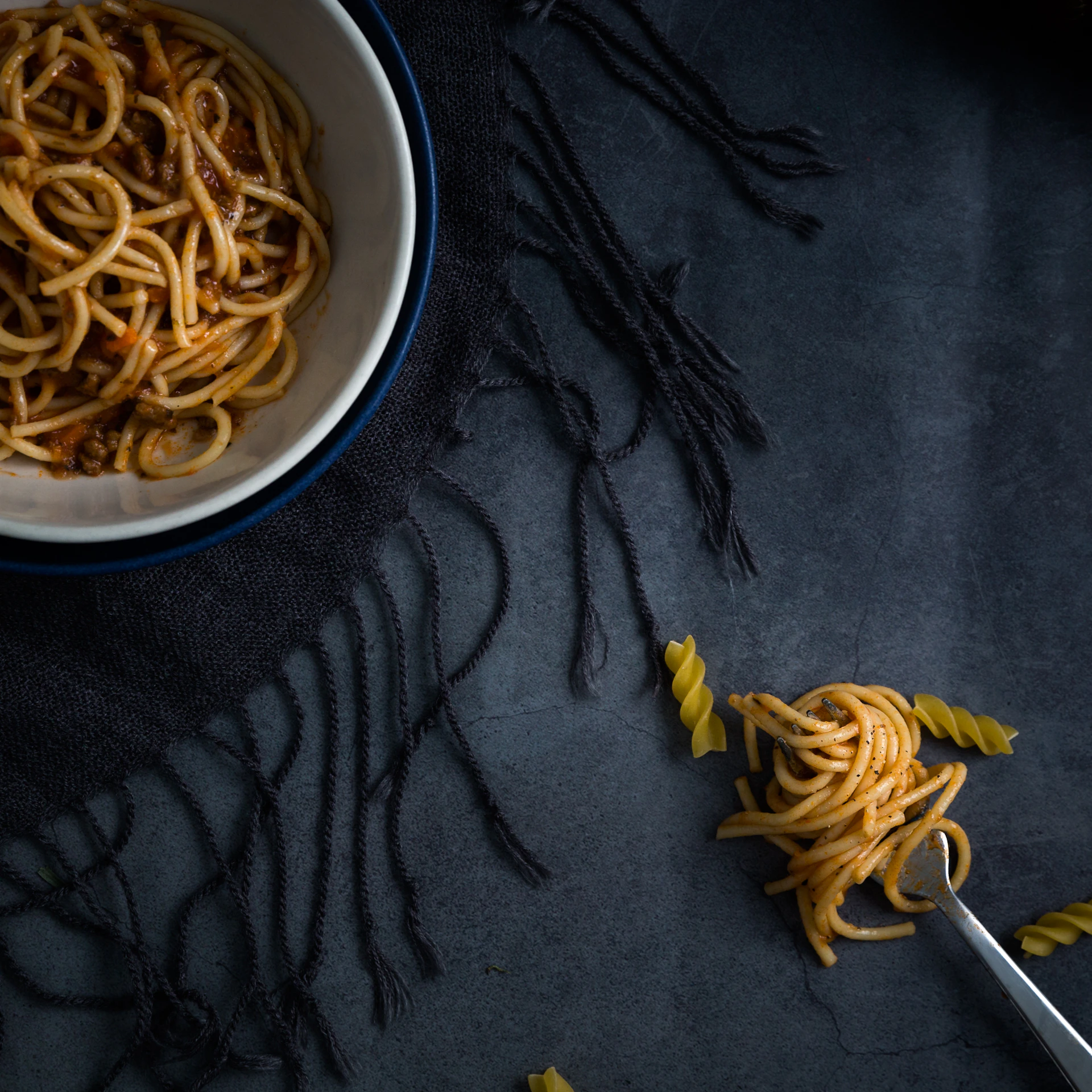 spaghetti on white and blue bowl