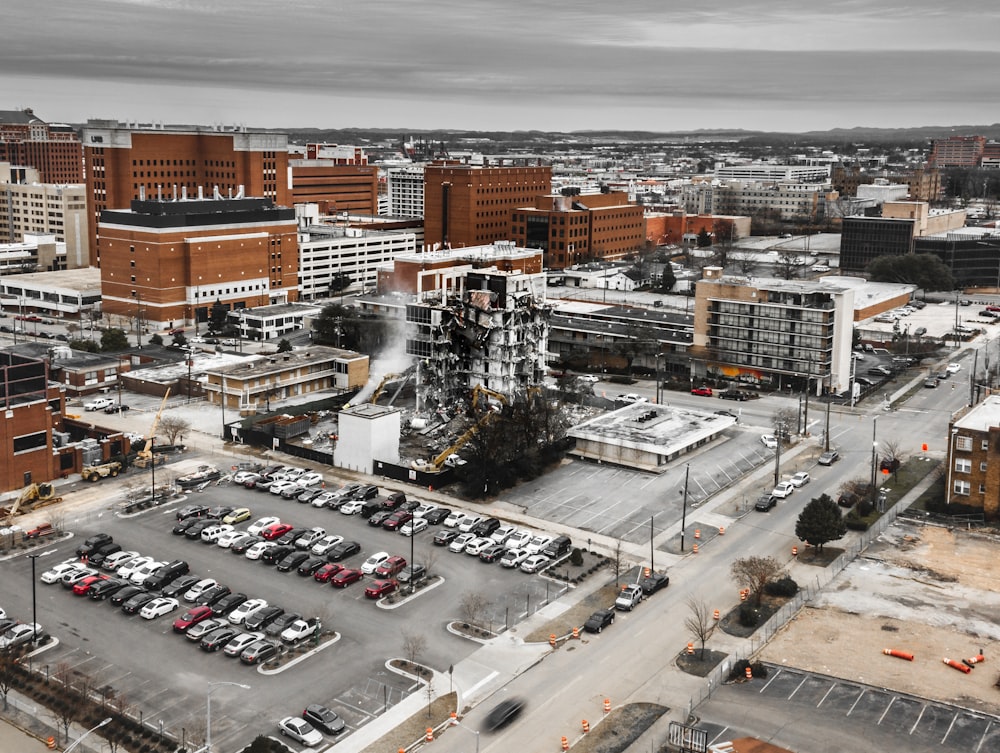 cars on park in middle of city under white sky