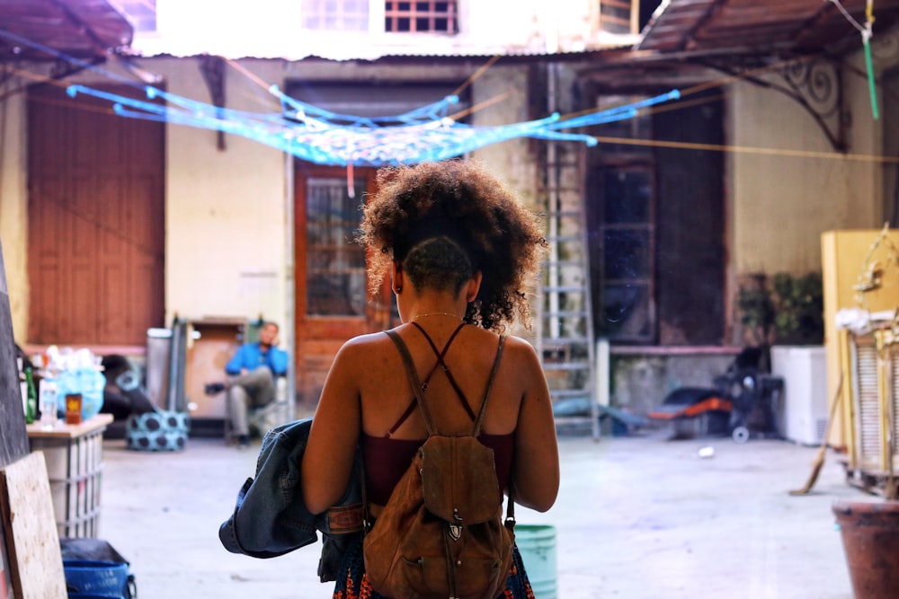 woman wearing brown backpack