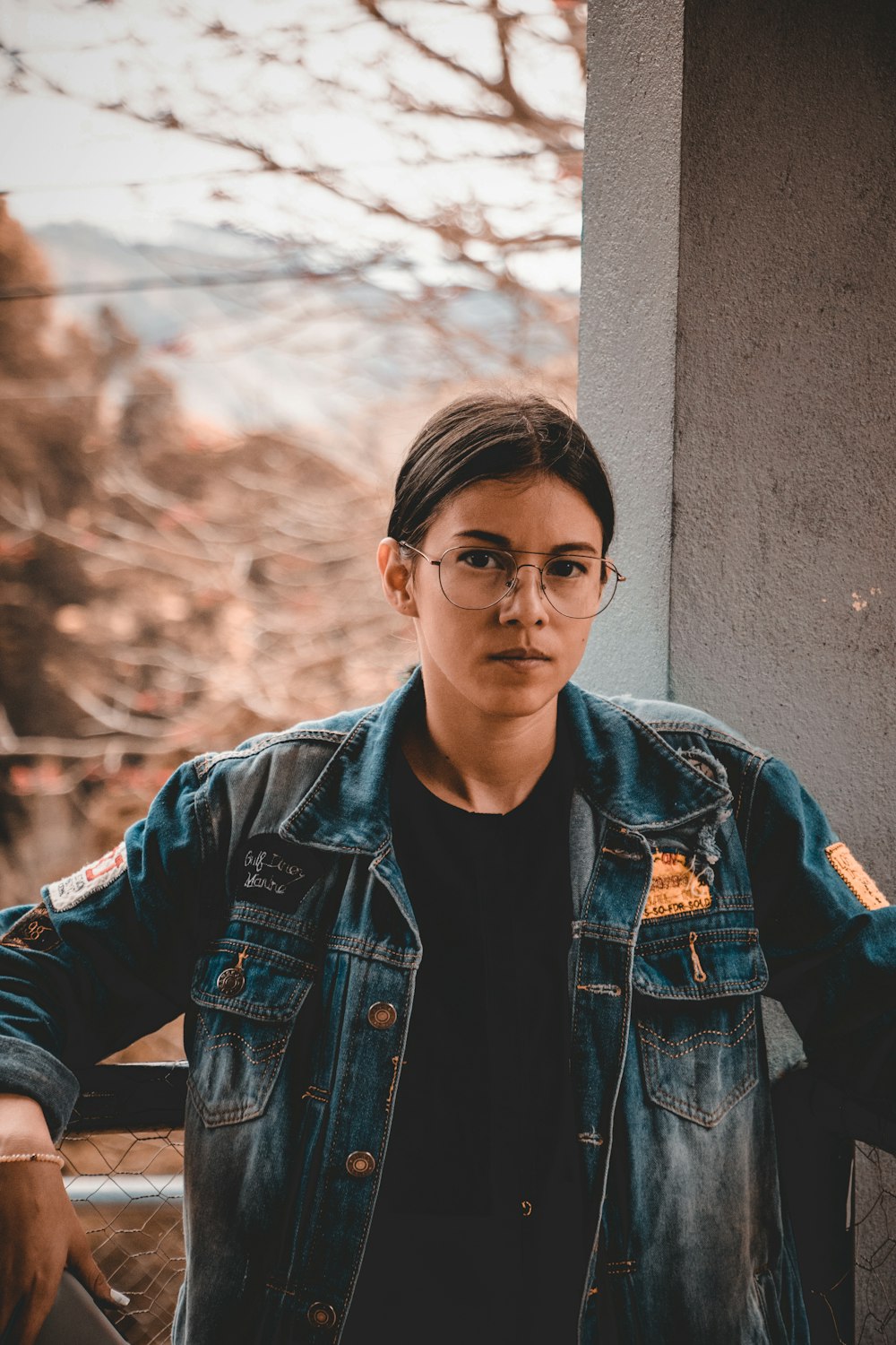 shallow focus photo of woman in blue denim jacket