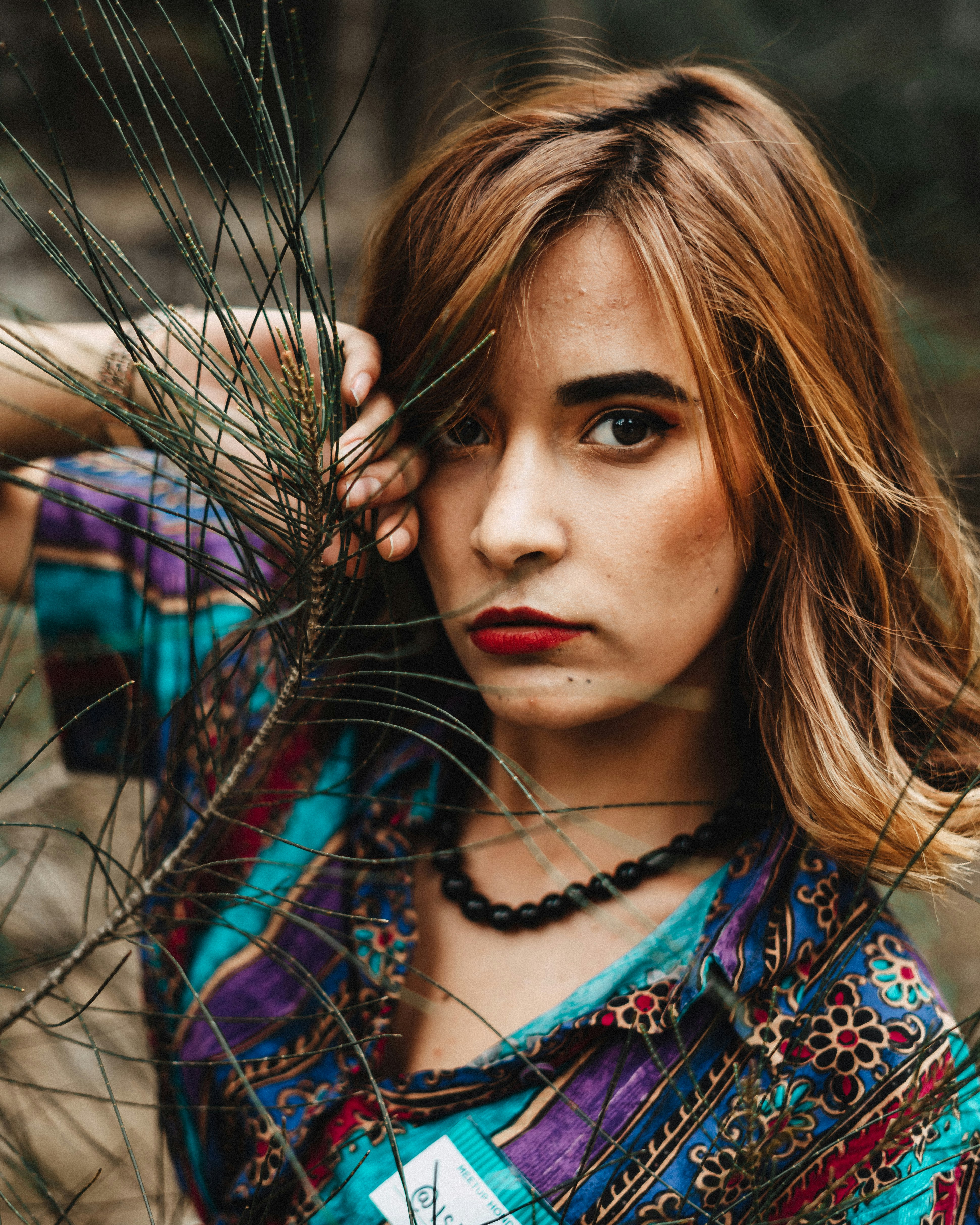 woman beside leaf plant in close-up photo