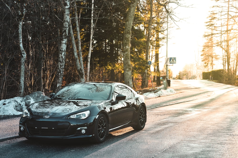 black vehicle on road during daytime