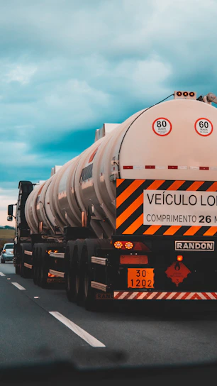 white and black oil tanker on road during daytime