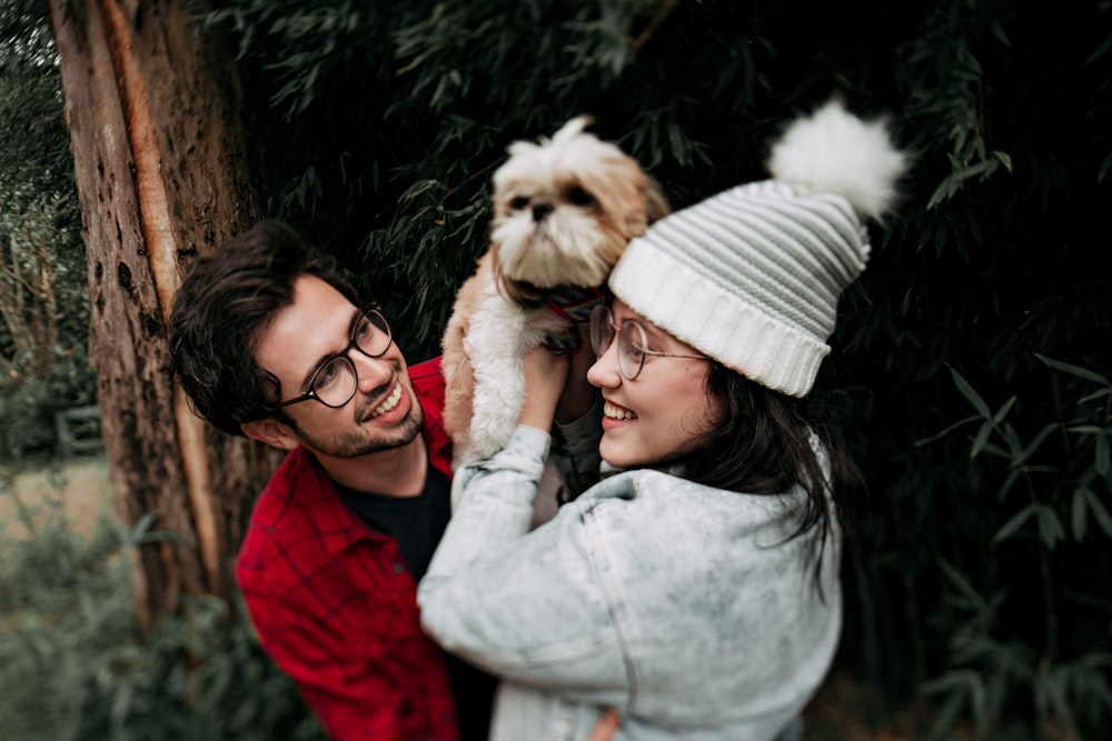 woman holding Shih Tzu puppy beside smiling man