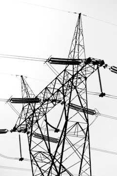 Wide shot of a large industrial facility featuring numerous electrical insulators on transmission towers.