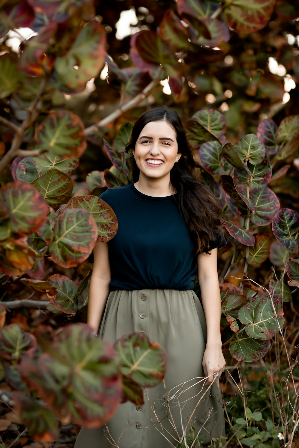 smiling woman surrounded with plants