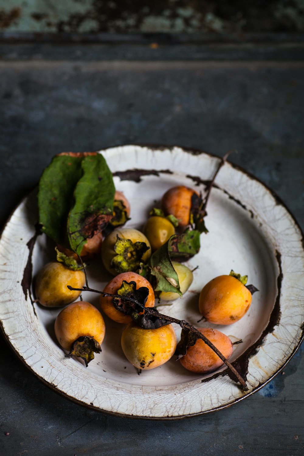 round yellow fruits on ceramic plate