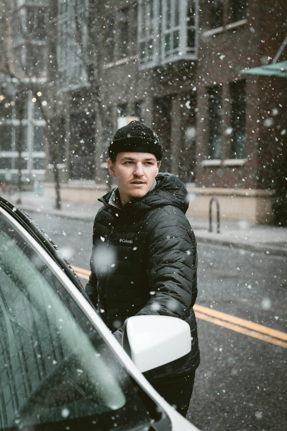 man standing beside vehicle while looking to his left