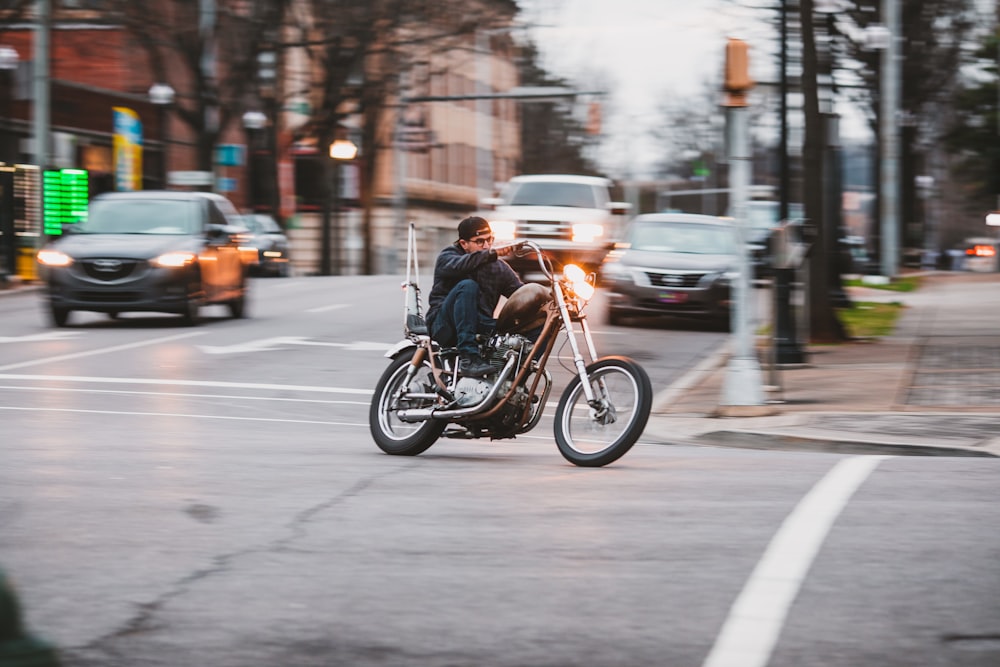 man riding motorcycle on road during daytime