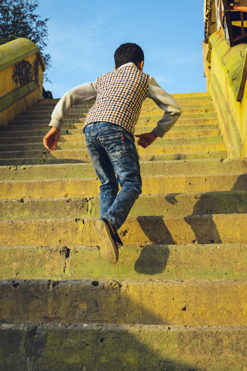 running boy on stairs during daytime