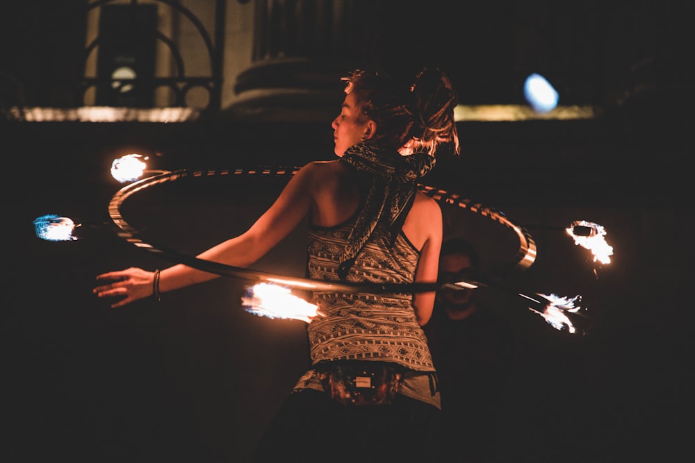 woman using hula-hoop at night