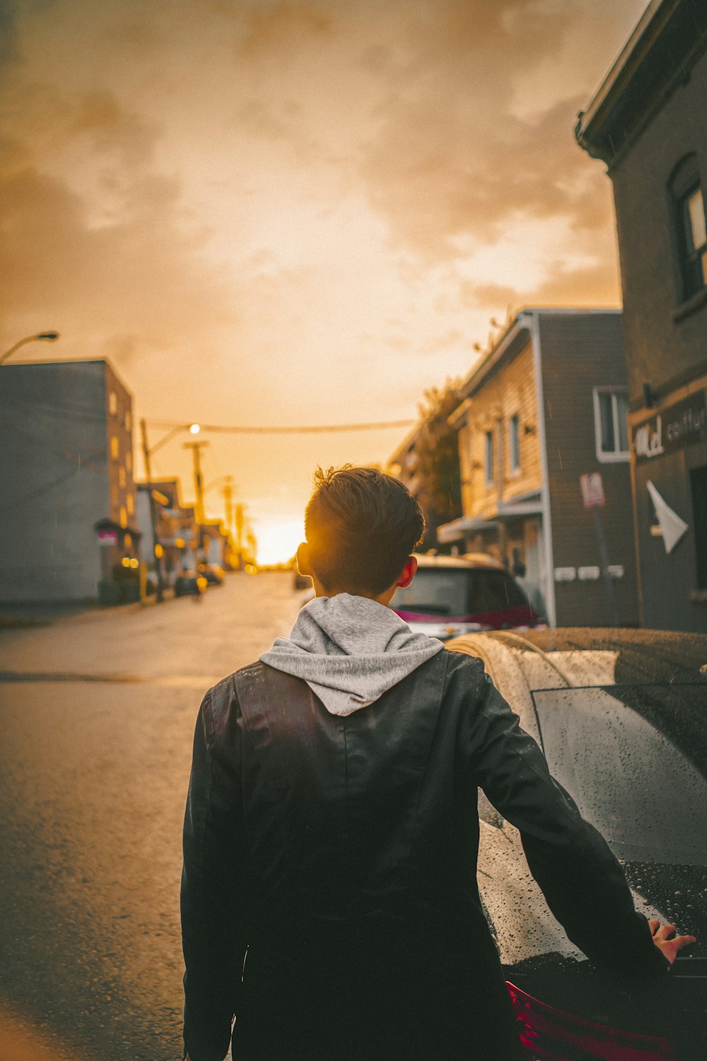 person wearing black and gray jacket during golden hour