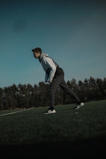 An outdoor scene featuring individuals in performance hoodies engaging in training activities.